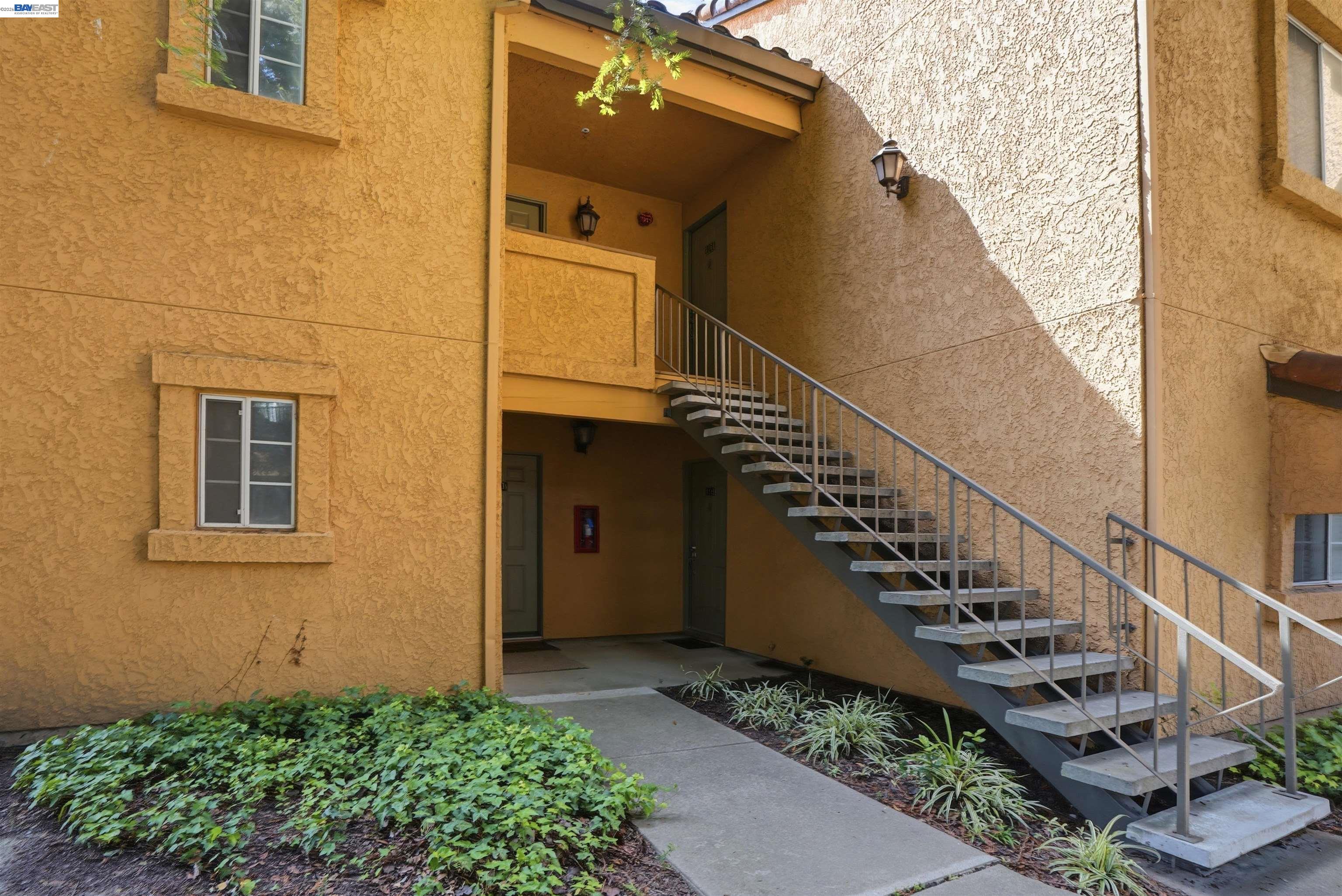 735 Watson Canyon Court, Unit 218 San Ramon, CA 94582 - Photo 15 of 18 a view of a house with wooden stairs and floor to ceiling windows