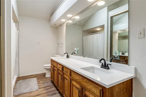 a bathroom with 2 sink and a mirror