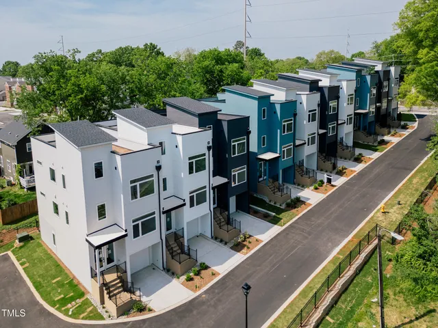 an aerial view of a house with porch and garden