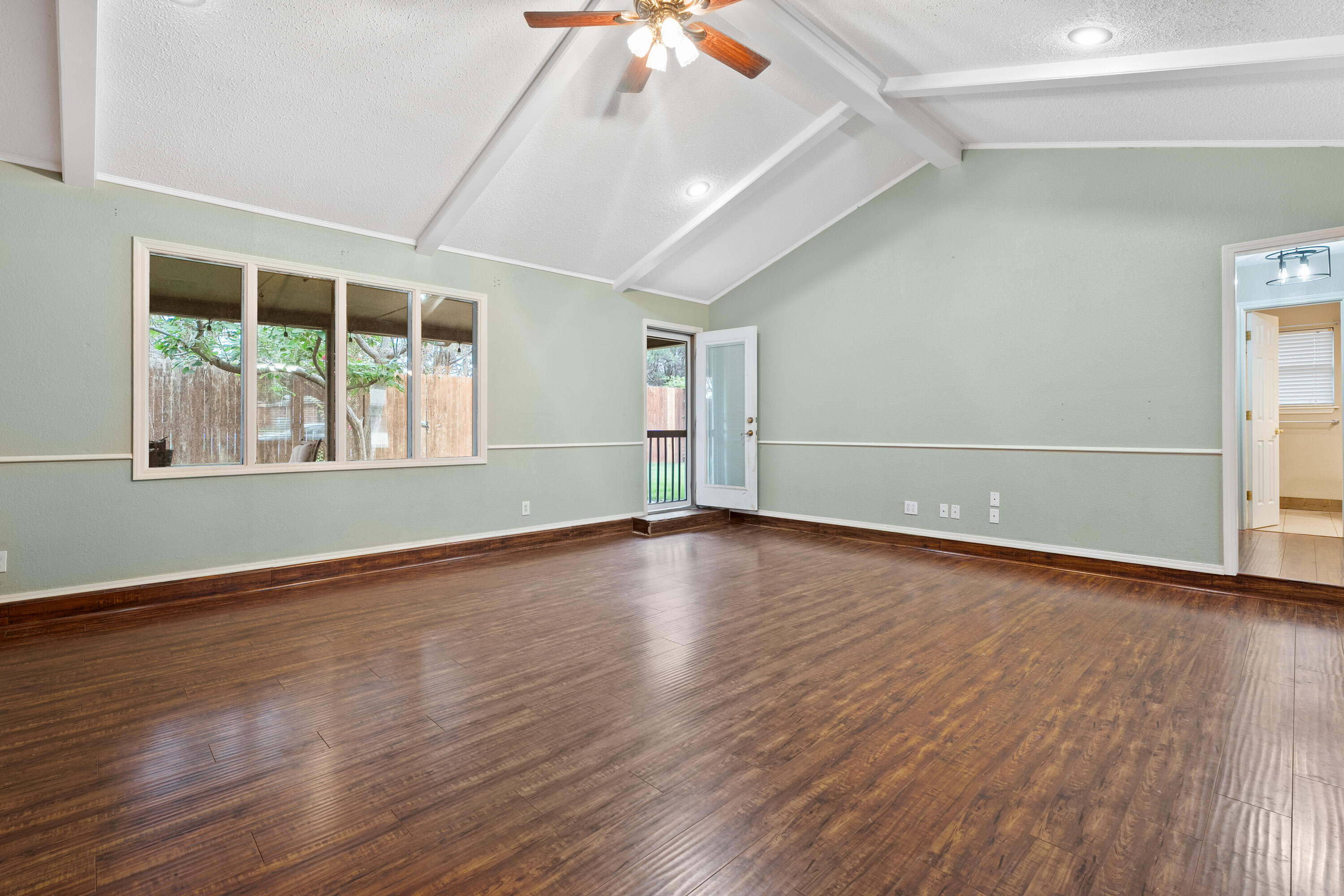 4403 78th Street Lubbock, TX 79424 - Photo 11 of 29 an empty room with wooden floor and windows