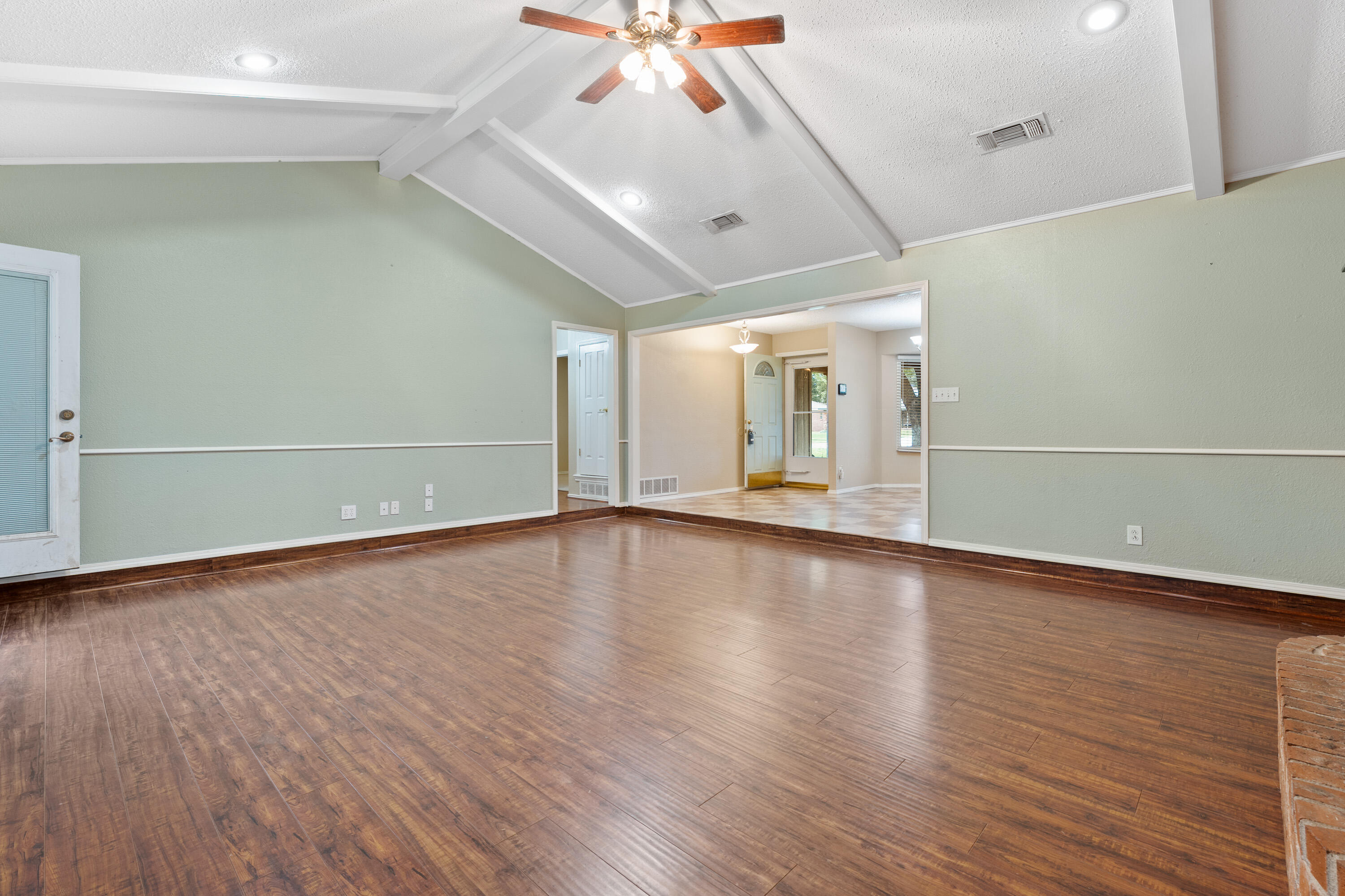 4403 78th Street Lubbock, TX 79424 - Photo 13 of 29 wooden floor in an empty room with a window