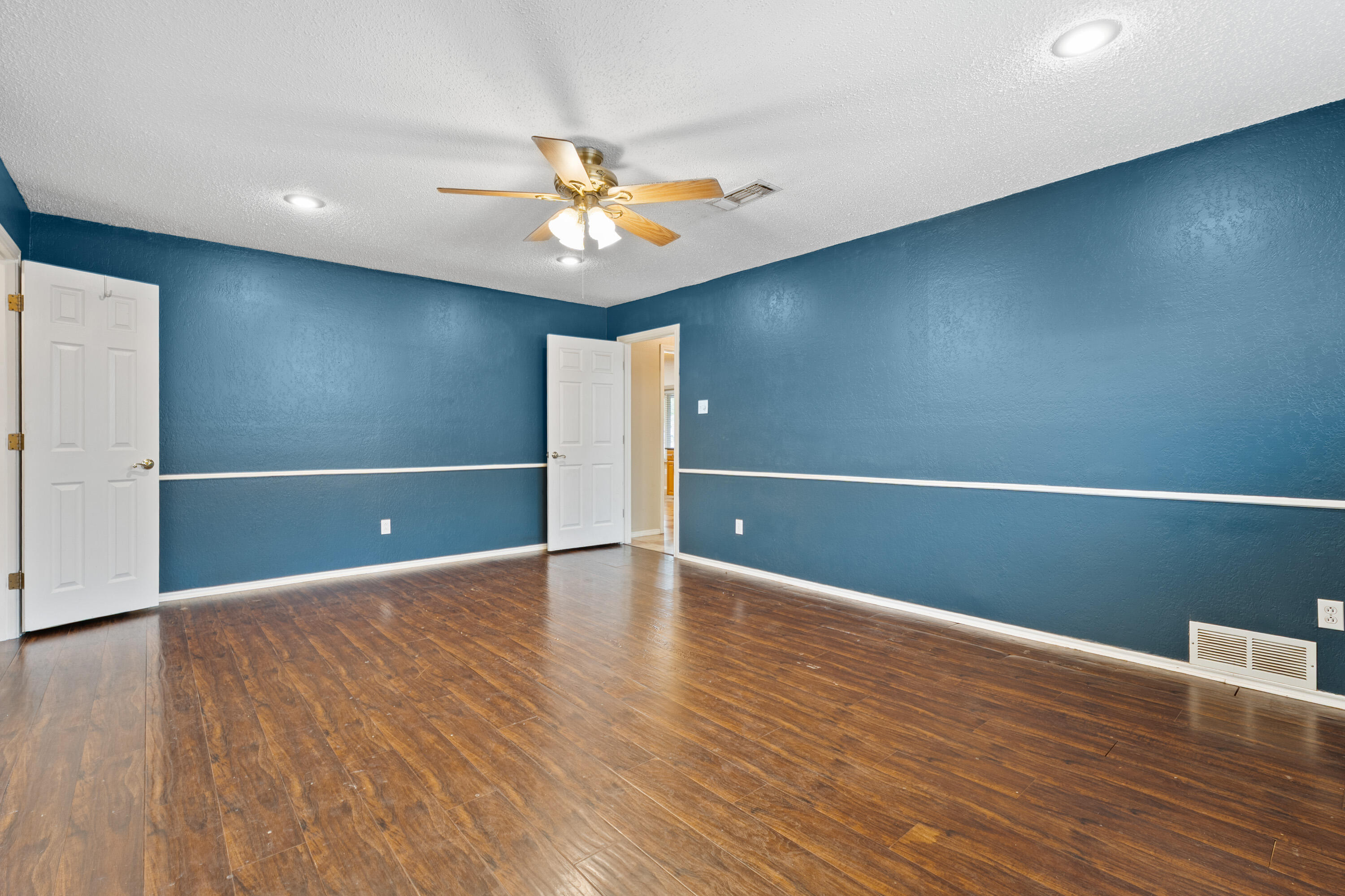 4403 78th Street Lubbock, TX 79424 - Photo 15 of 29 a view of an empty room with wooden floor