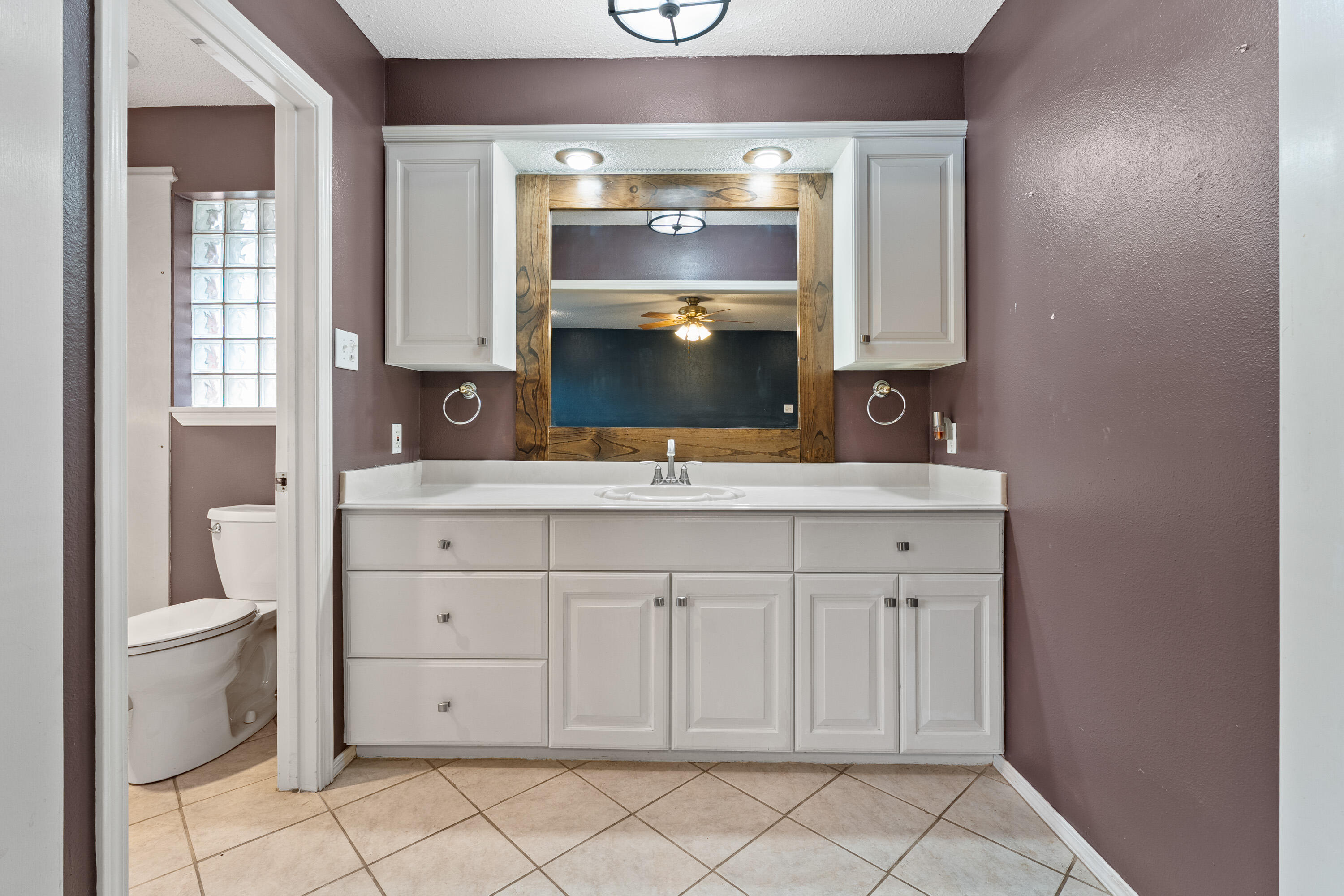 4403 78th Street Lubbock, TX 79424 - Photo 16 of 29 a bathroom with a sink vanity and a toilet