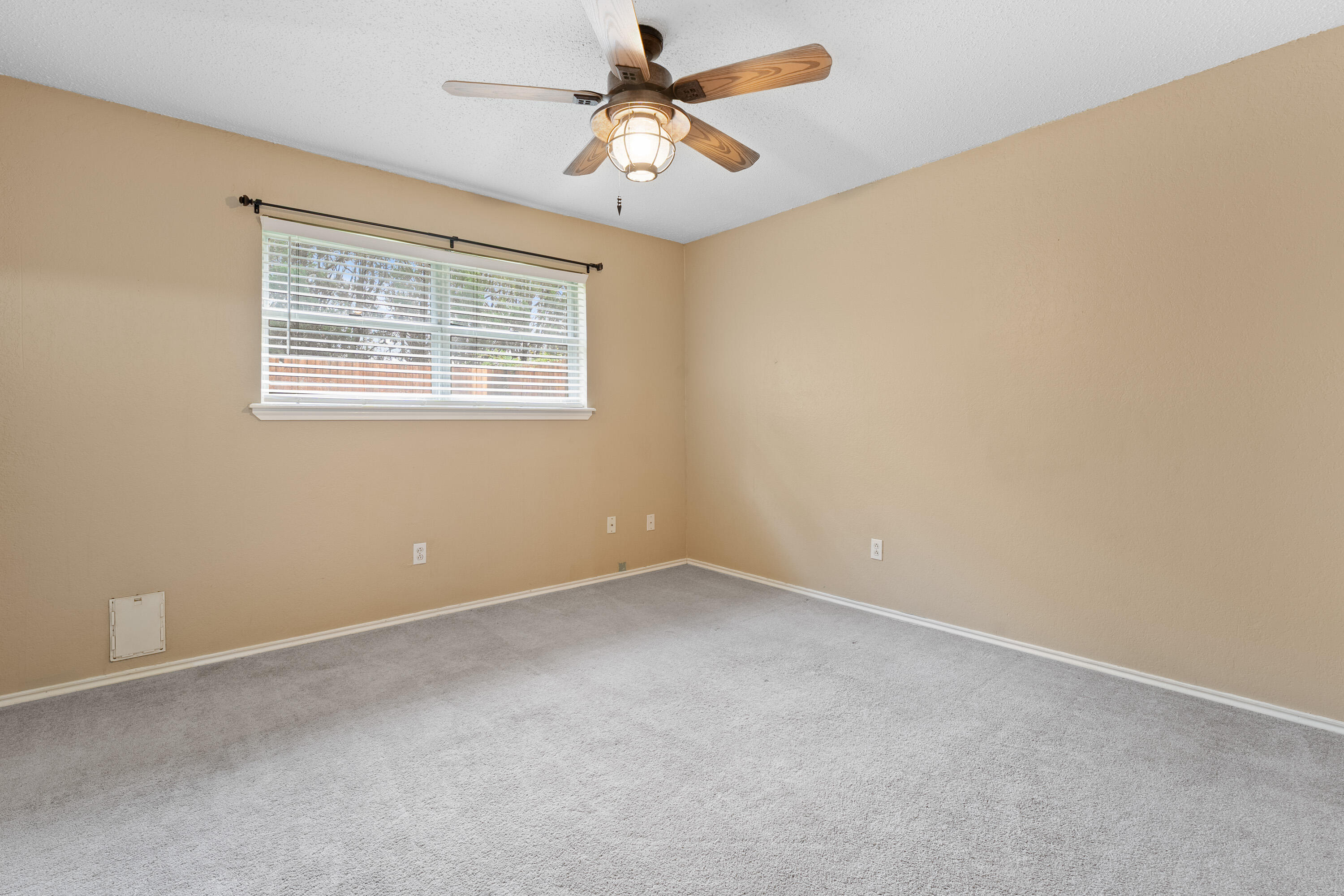 4403 78th Street Lubbock, TX 79424 - Photo 23 of 29 an empty room with a window and a ceiling fan