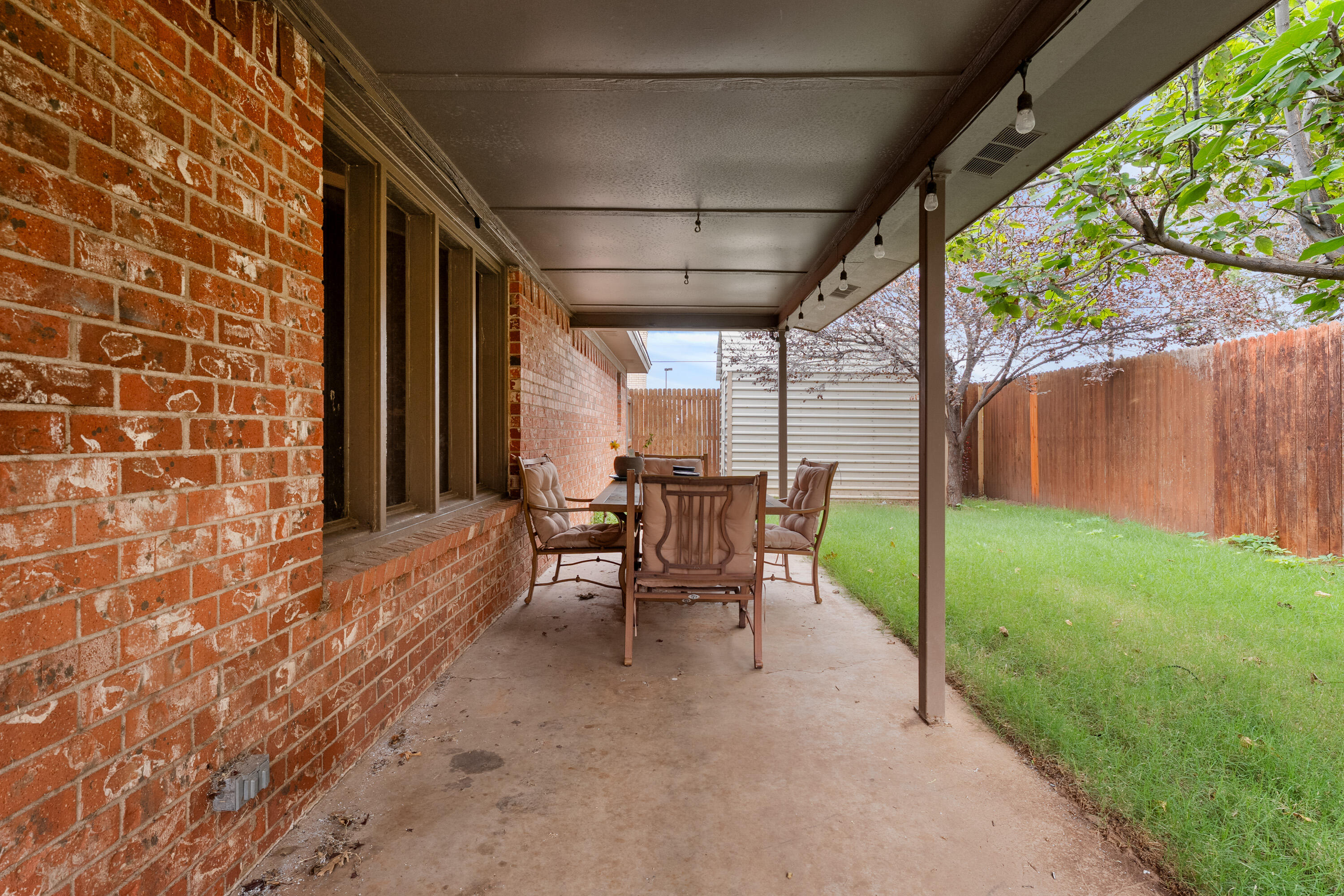 4403 78th Street Lubbock, TX 79424 - Photo 25 of 29 a view of a porch with chairs and backyard