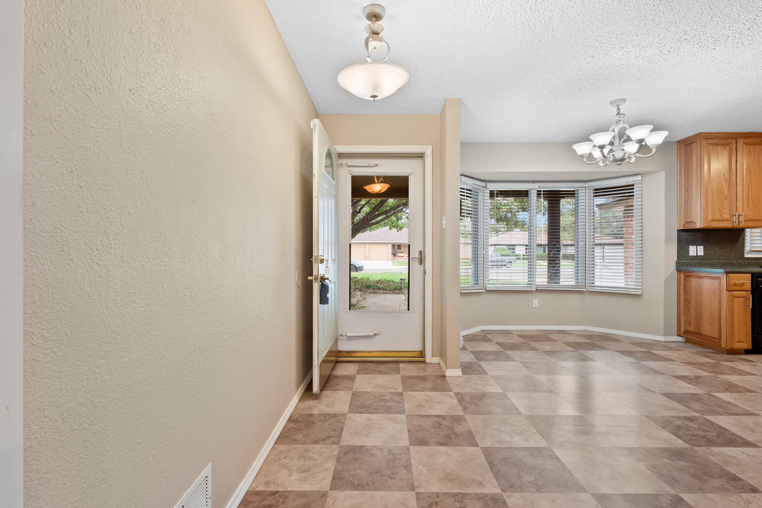4403 78th Street Lubbock, TX 79424 - Photo 5 of 29 a view of an entryway with wooden floor and a window