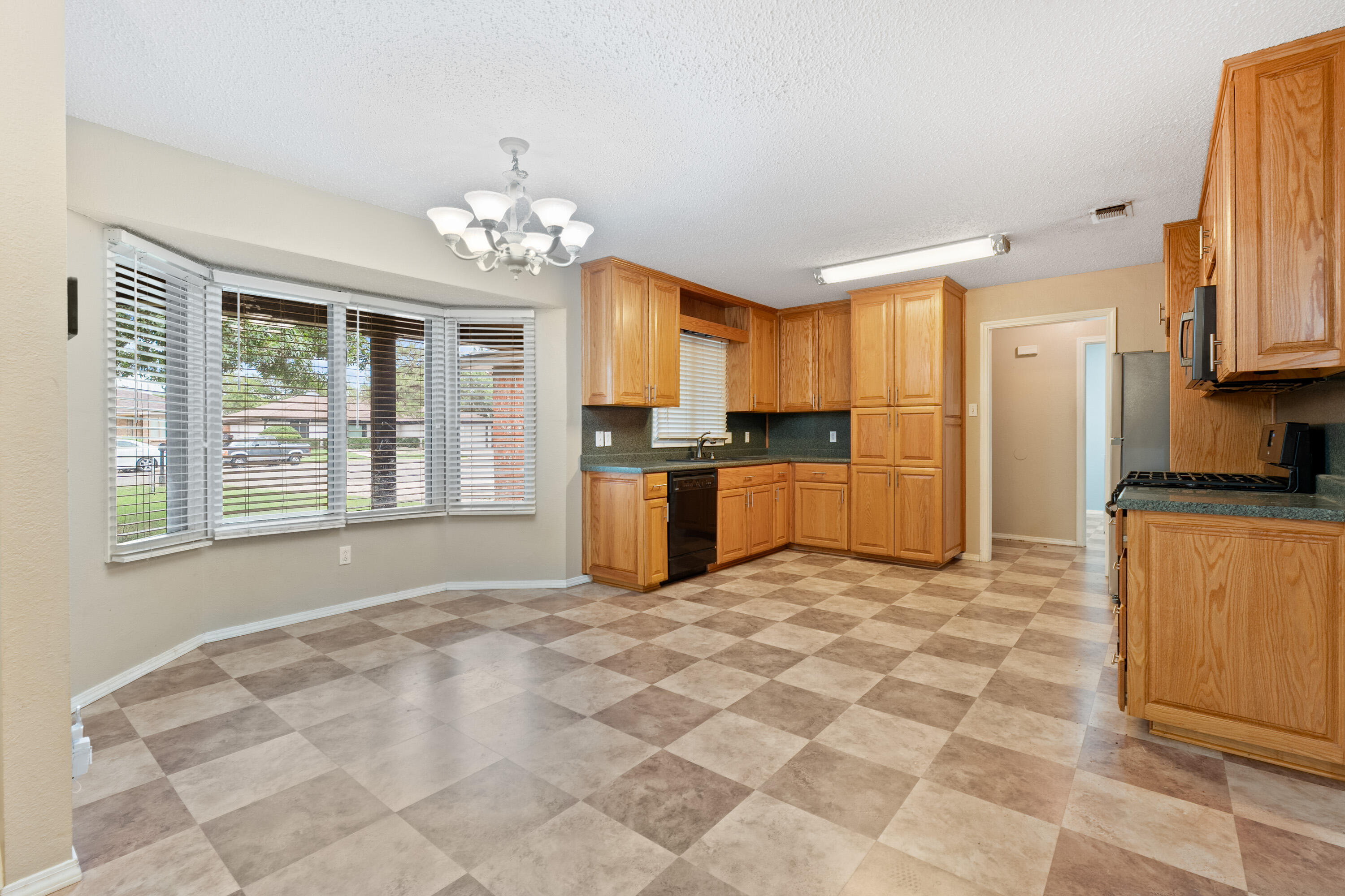 4403 78th Street Lubbock, TX 79424 - Photo 6 of 29 a large kitchen with cabinets and stainless steel appliances