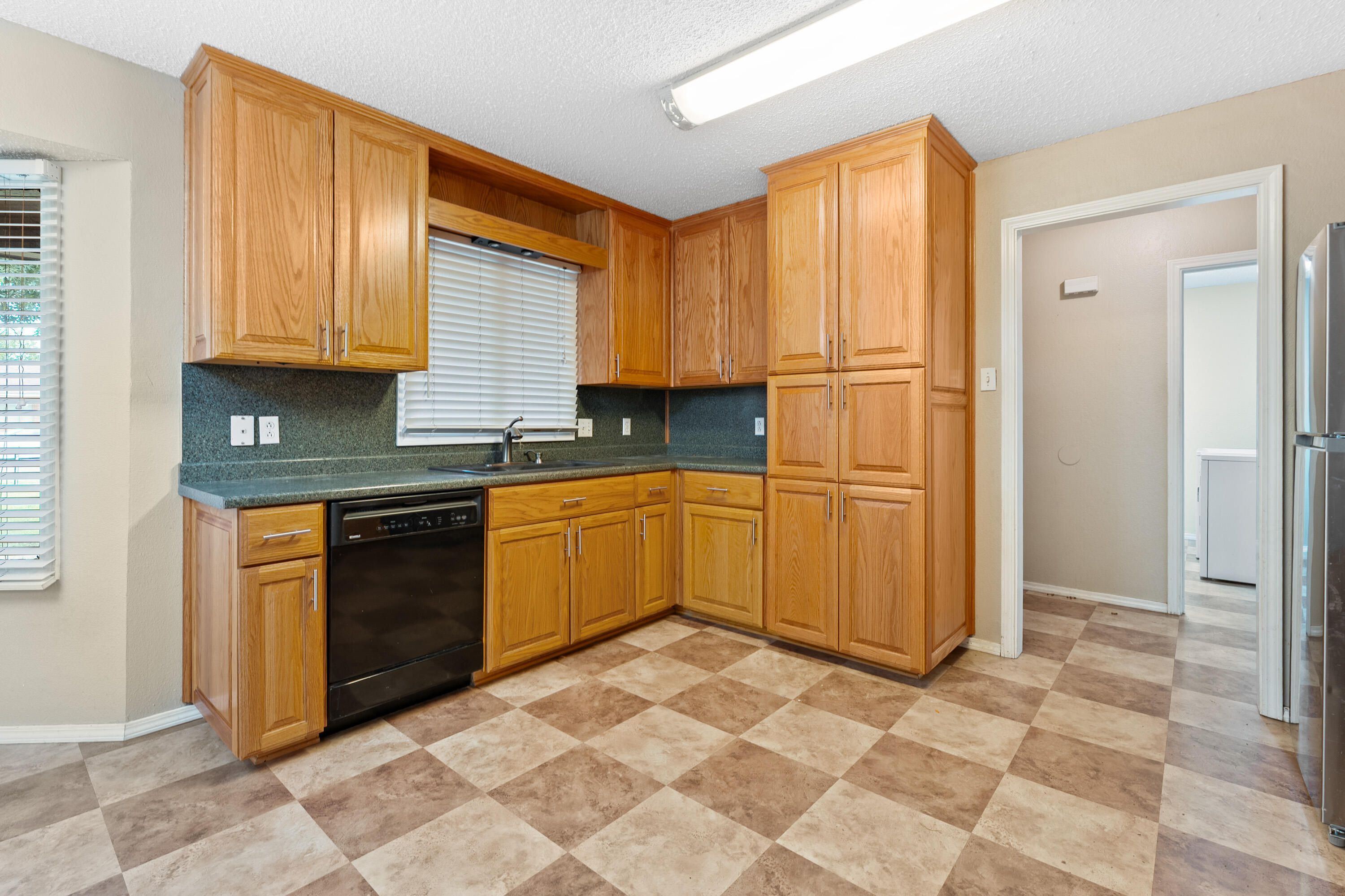 4403 78th Street Lubbock, TX 79424 - Photo 9 of 29 a kitchen with stainless steel appliances granite countertop a stove a sink and a refrigerator