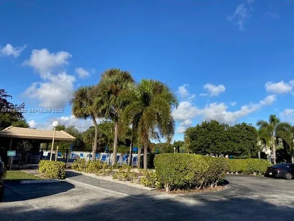 a view of a water fountain and a big house