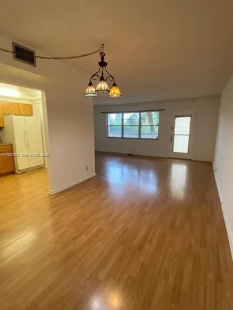 a view of livingroom and kitchen with wooden floor