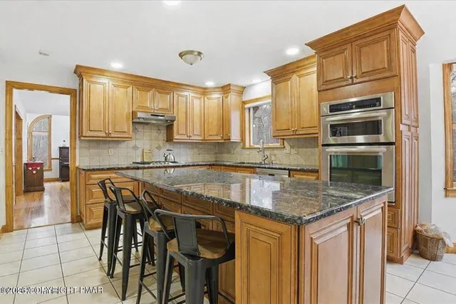 a room with wooden floor pool table and wooden floor