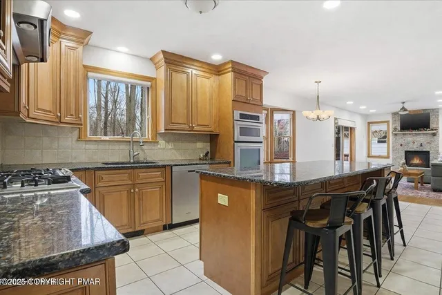 a room with furniture pool table and wooden floor