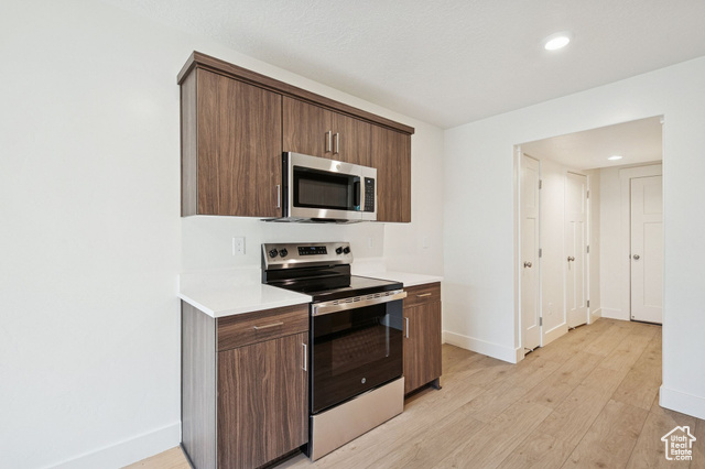 1615 North Angel Street, Unit E Layton, UT 84041 - Photo 13 of 42 Kitchen with stainless steel appliances, modern cabinets, light wood-style floors, recessed lighting, and dark brown cabinets