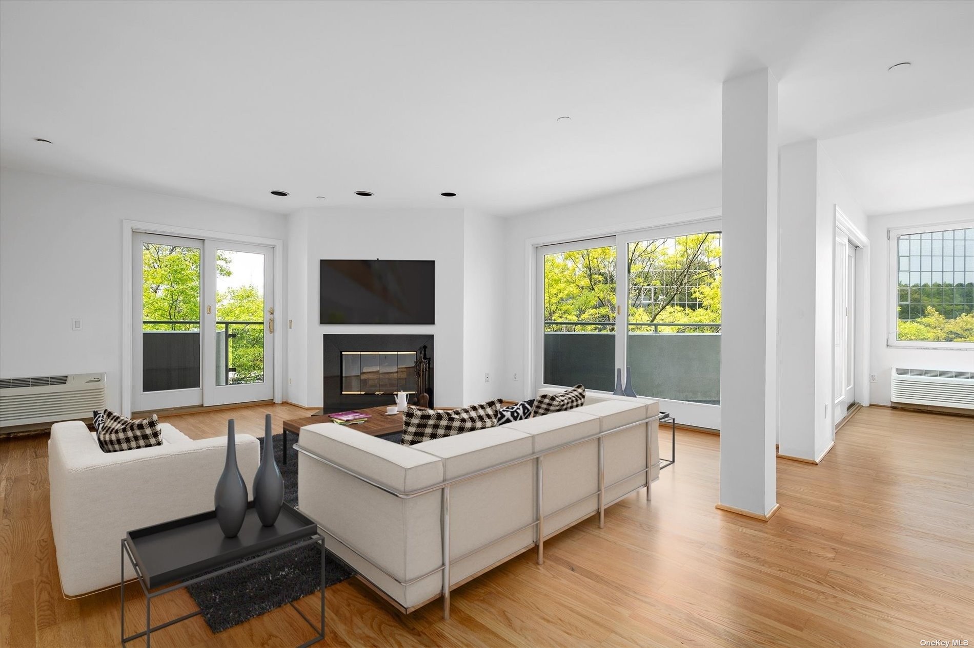 a living room with furniture fireplace and window
