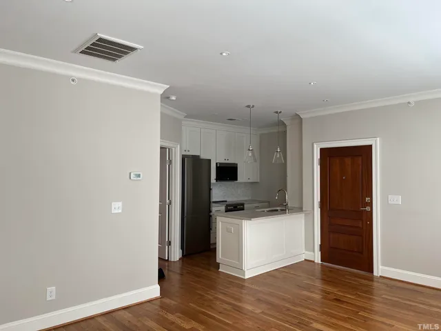 a kitchen with a refrigerator and a stove top oven