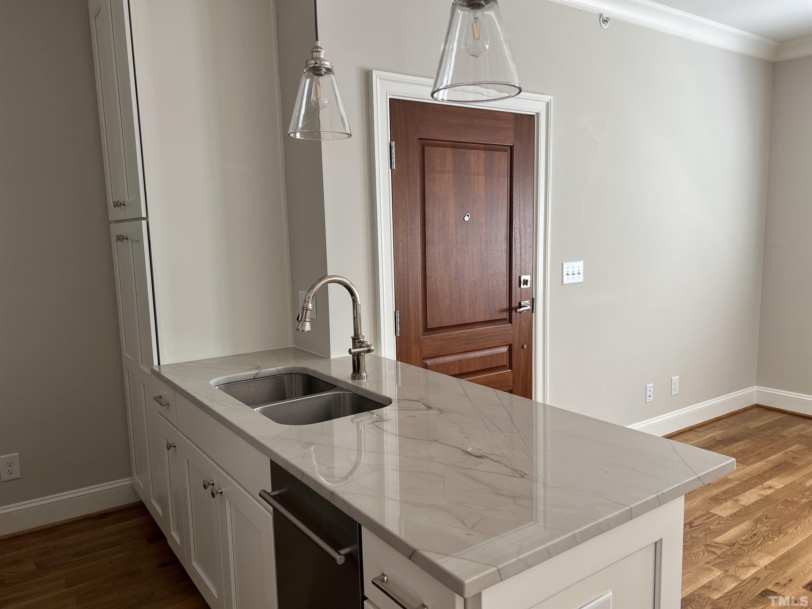 604 Daniels Street, Unit C Raleigh, NC 27605 - Photo 16 of 34 a kitchen with stainless steel appliances granite countertop a sink and a refrigerator