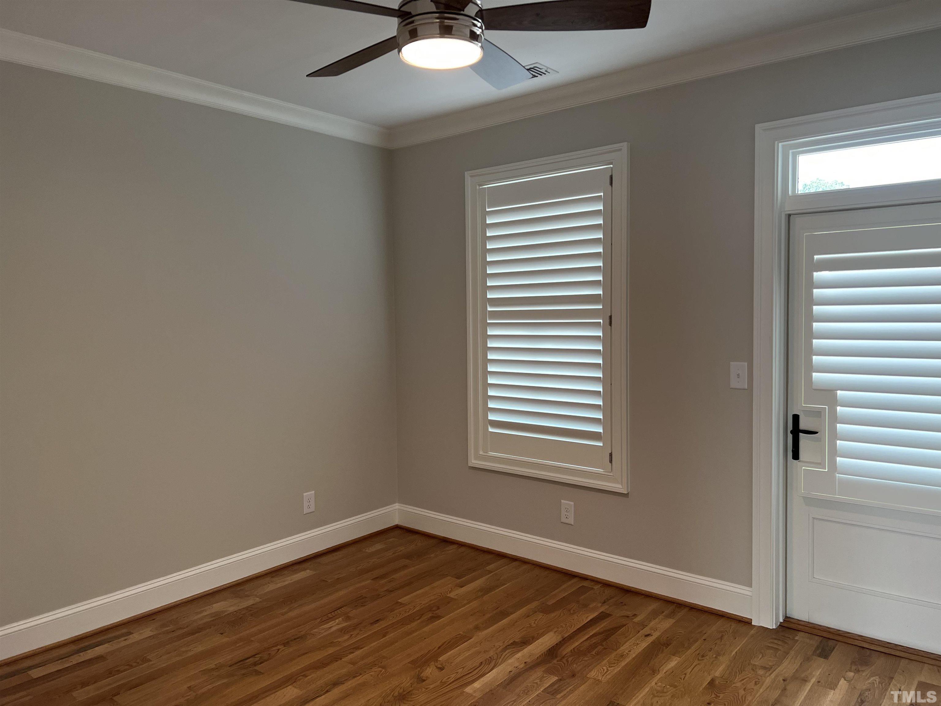 604 Daniels Street, Unit C Raleigh, NC 27605 - Photo 17 of 34 a view of an empty room with wooden floor and a window