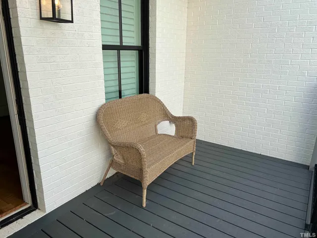 a view of a hallway with wooden floor and a potted plant