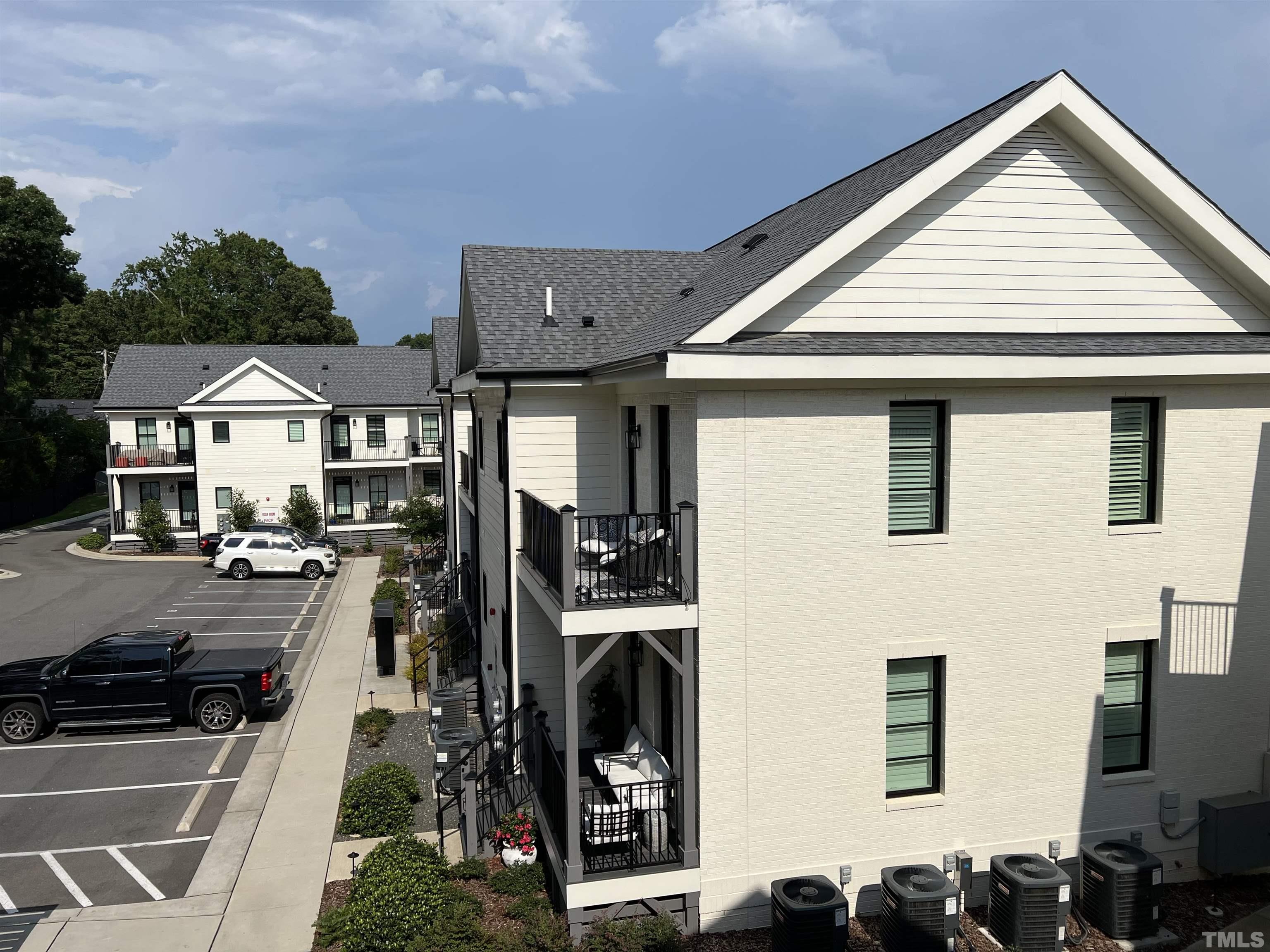 604 Daniels Street, Unit C Raleigh, NC 27605 - Photo 21 of 34 a view of a patio with chairs and potted plants