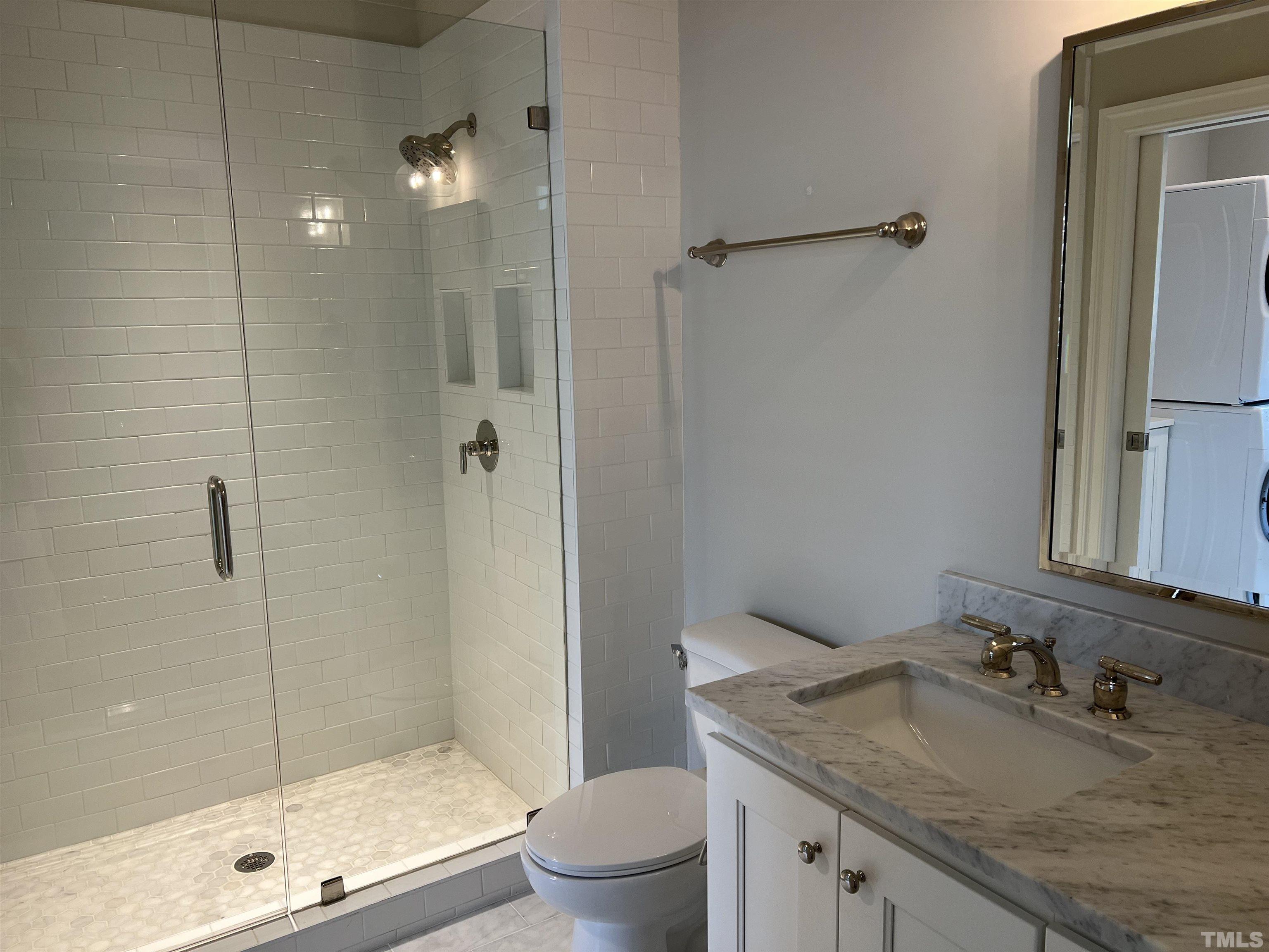 604 Daniels Street, Unit C Raleigh, NC 27605 - Photo 24 of 34 a bathroom with a granite countertop sink a toilet and shower