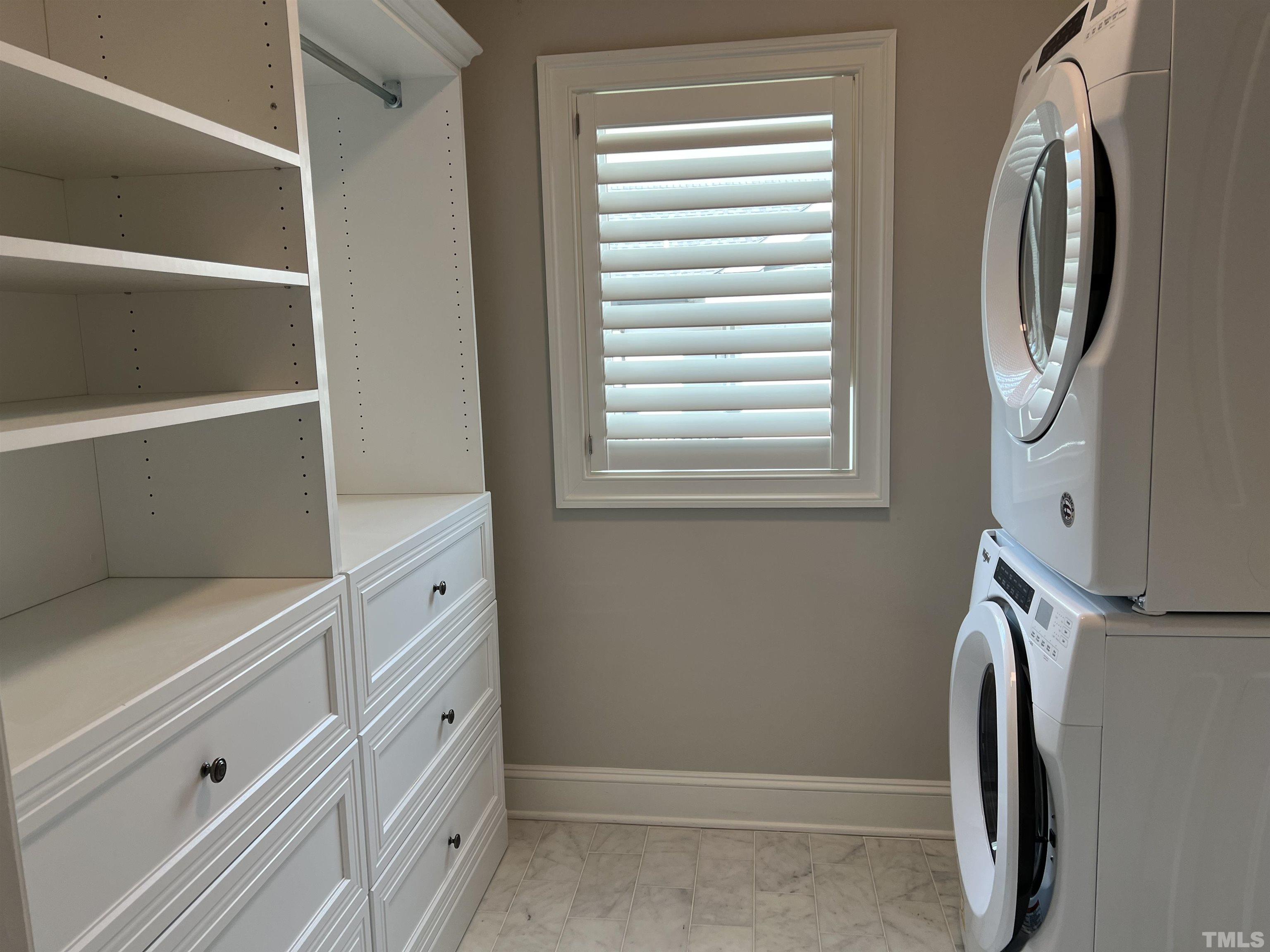 604 Daniels Street, Unit C Raleigh, NC 27605 - Photo 25 of 34 a view of walk in closet with clothes and shoes