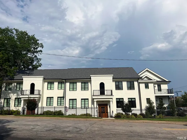 a front view of residential houses with yard