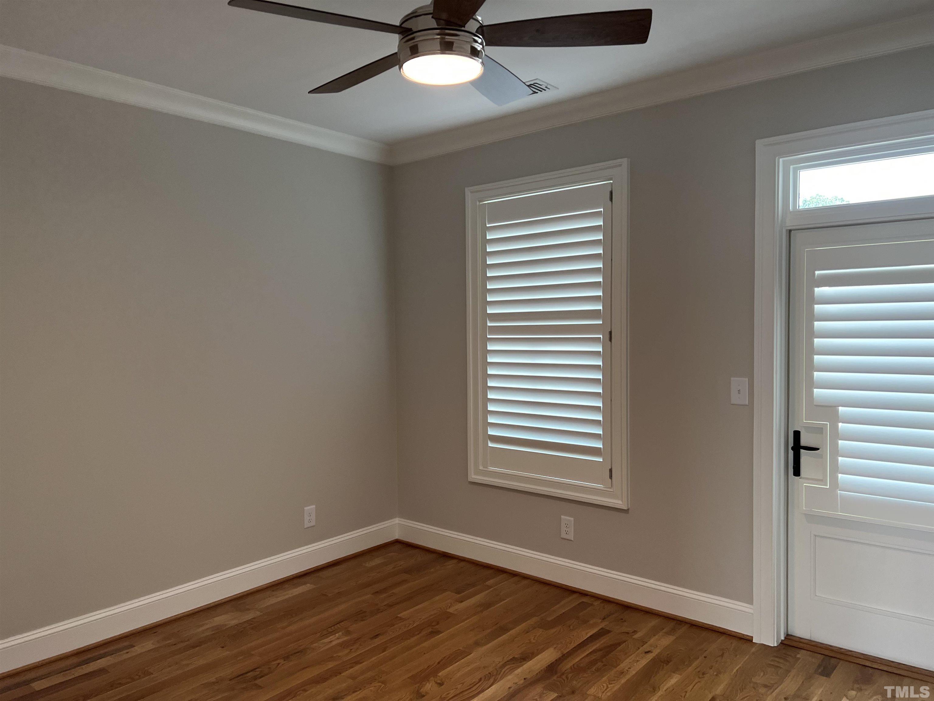 604 Daniels Street, Unit C Raleigh, NC 27605 - Photo 32 of 34 a view of an empty room with wooden floor and a window