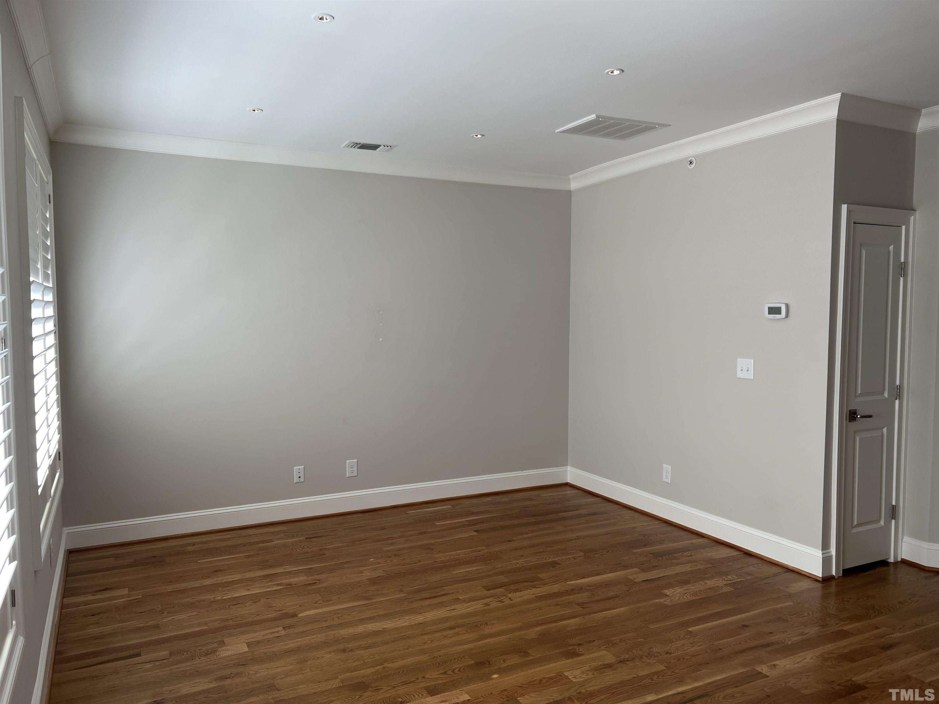 604 Daniels Street, Unit C Raleigh, NC 27605 - Photo 33 of 34 a view of an empty room with wooden floor
