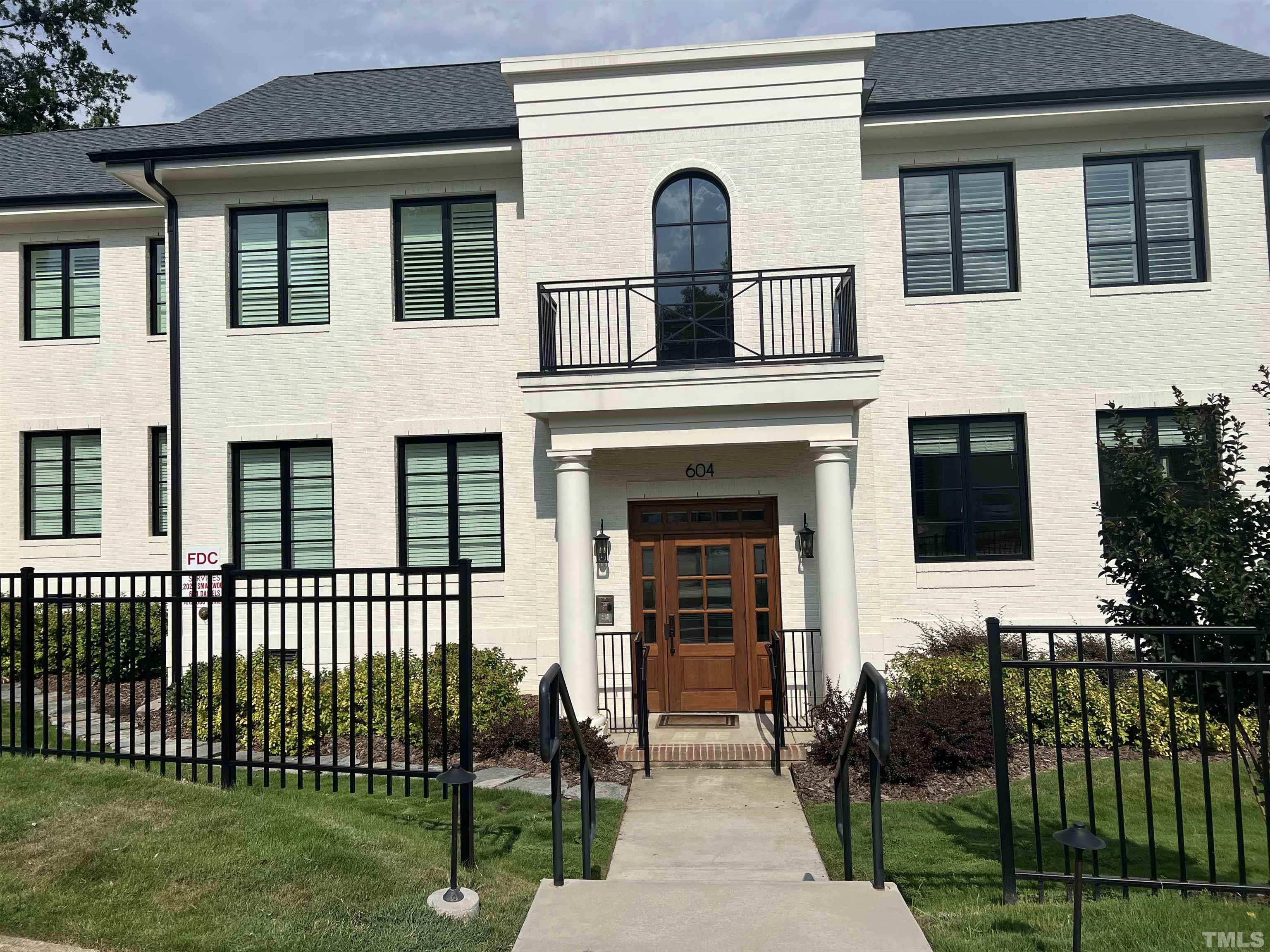 604 Daniels Street, Unit C Raleigh, NC 27605 - Photo 5 of 34 a front view of a house with a yard