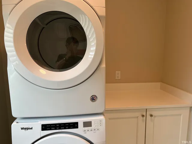 a close view of a utility room with dryer and washer