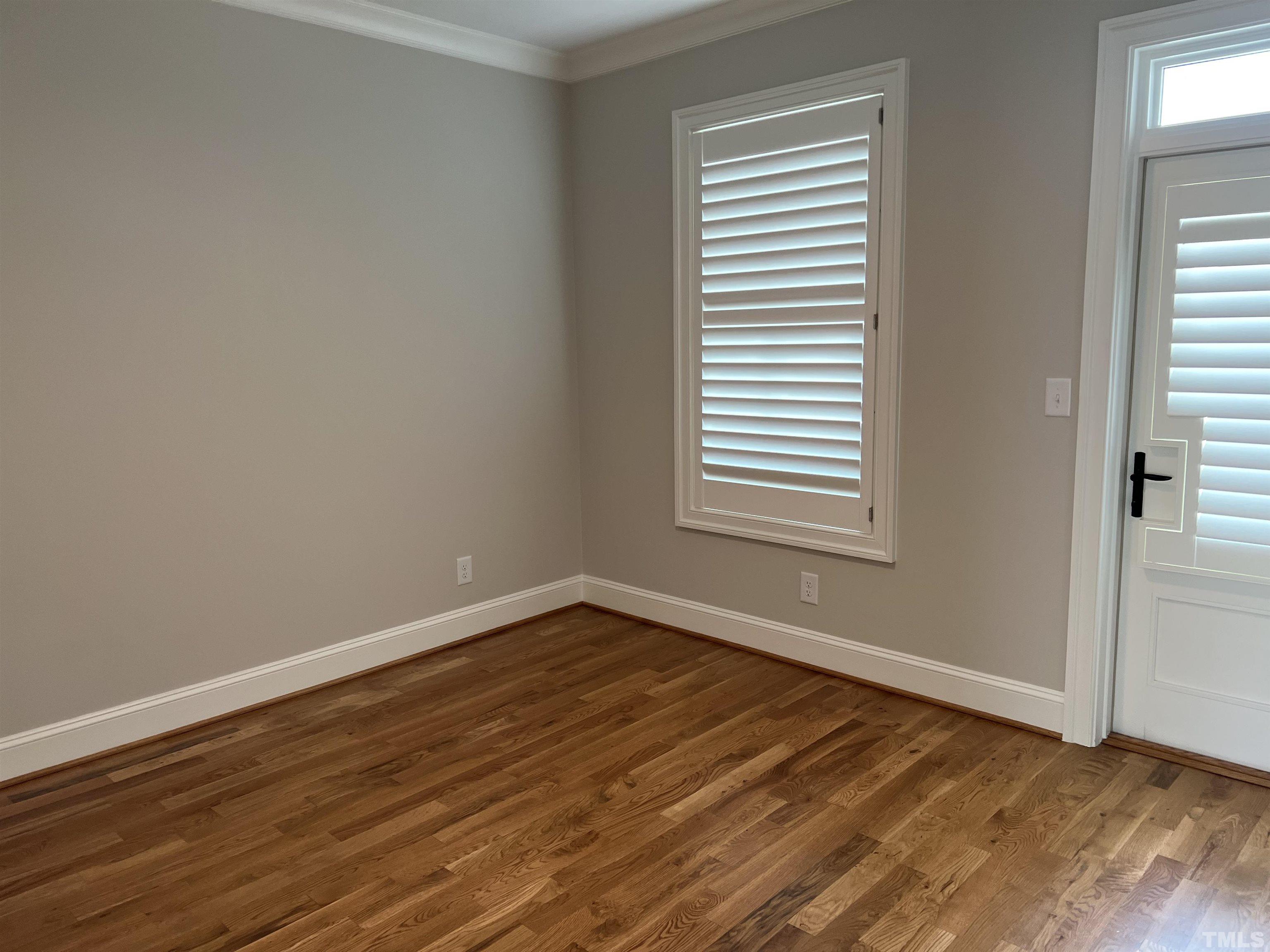 604 Daniels Street, Unit C Raleigh, NC 27605 - Photo 10 of 34 a view of an empty room with wooden floor and a window