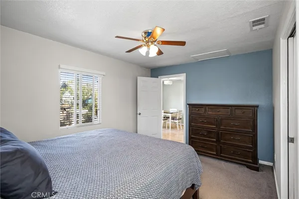 a bedroom with a bed and a dresser