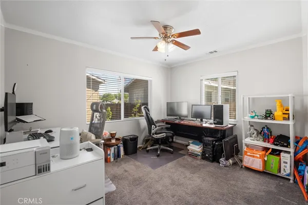 a view of a livingroom with workspace and a window
