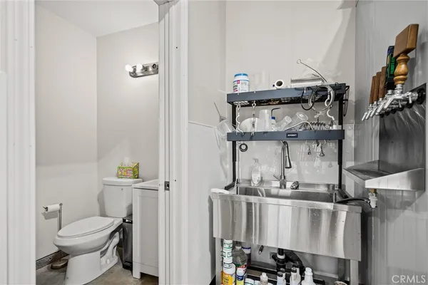 a bathroom with a toilet a sink and mirror
