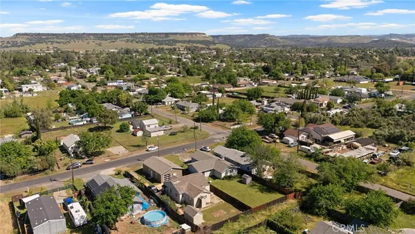 an aerial view of a house with a yard basket ball court and outdoor seating