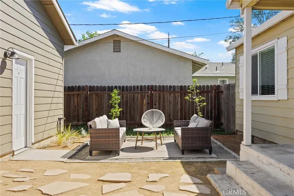 a view of a house with backyard and sitting area