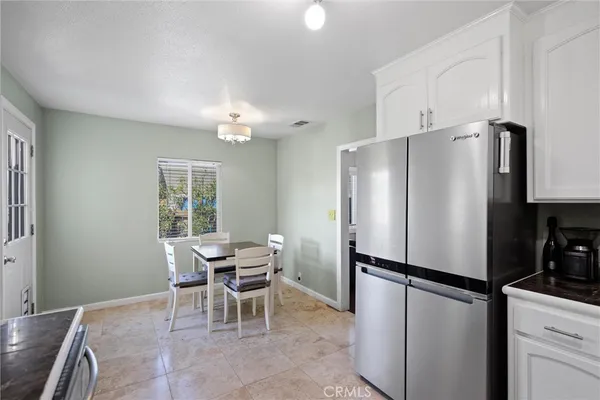 a kitchen with stainless steel appliances a refrigerator and a table