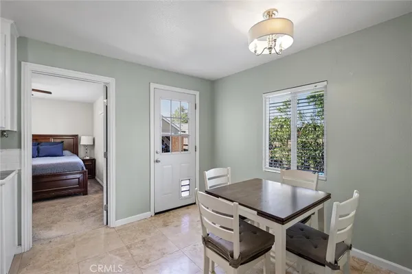 a view of a room that has a bed and a chandelier