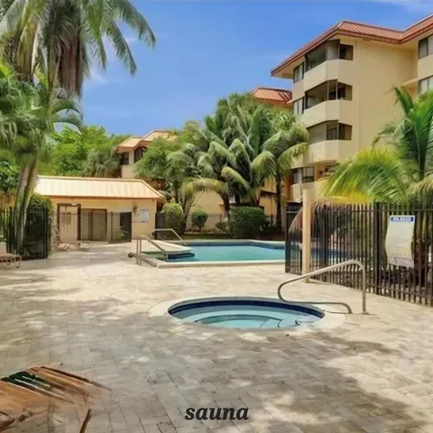 a view of a house with backyard and tree