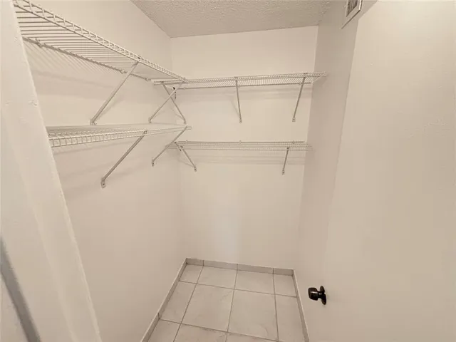 a bathroom with a sink vanity granite toilet and shower