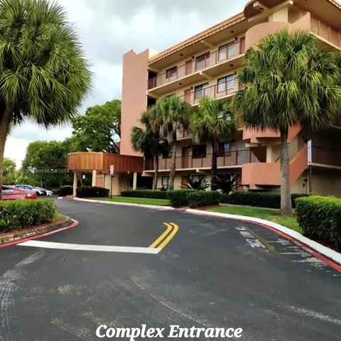 a front view of house with yard and trees around