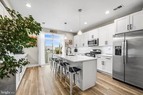 a kitchen with a sink stove and refrigerator