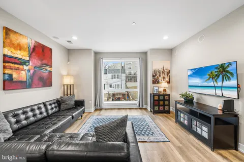 a view of a hallway with wooden floor and stairs