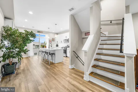 a kitchen with kitchen island granite countertop a center island a sink appliances and cabinets