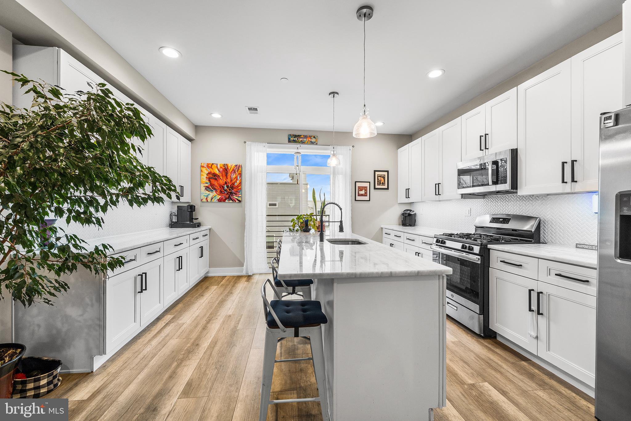 4736 Sheldon Street Philadelphia, PA 19127 - Photo 10 of 37 a kitchen with stainless steel appliances kitchen island granite countertop a lot of counter space and wooden floors