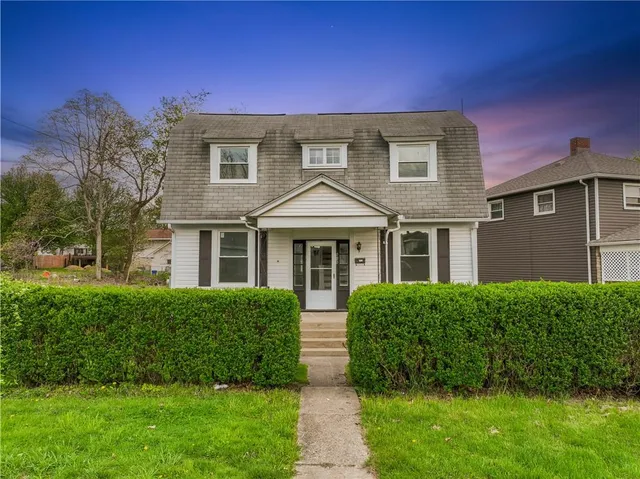 a front view of a house with a yard