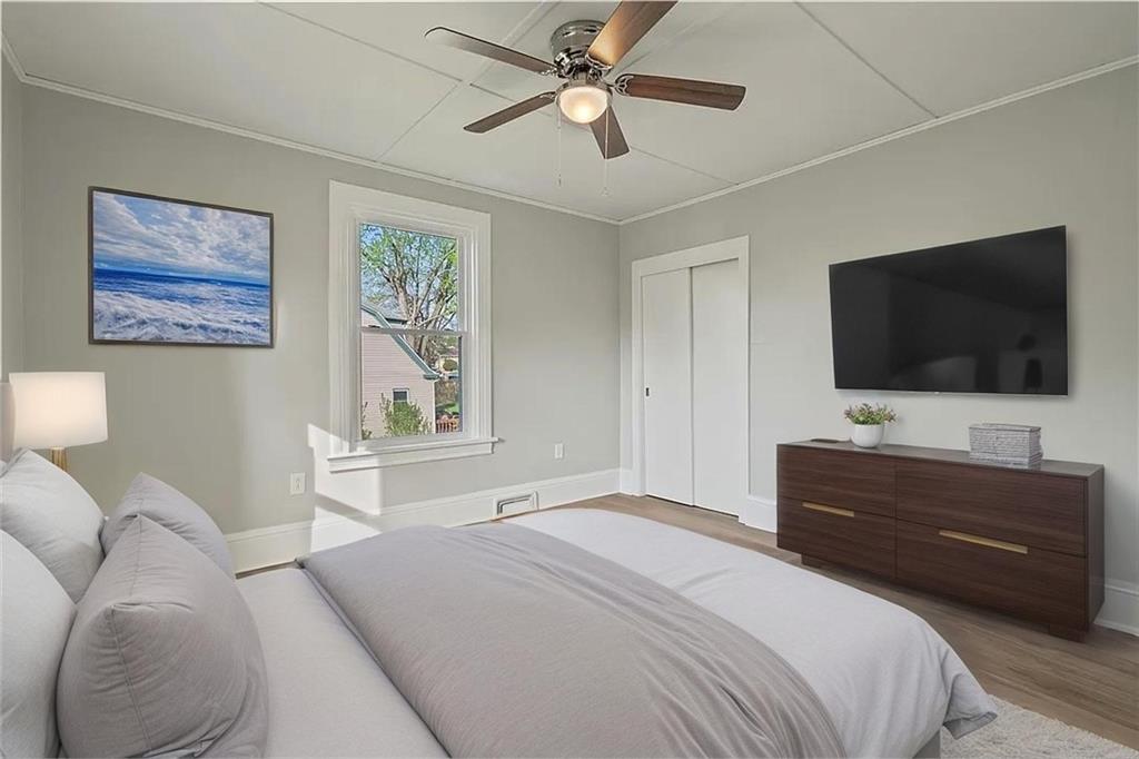 848 Ohio Avenue Monaca, PA 15061 - Photo 11 of 24 a bedroom with a bed and a flat screen tv