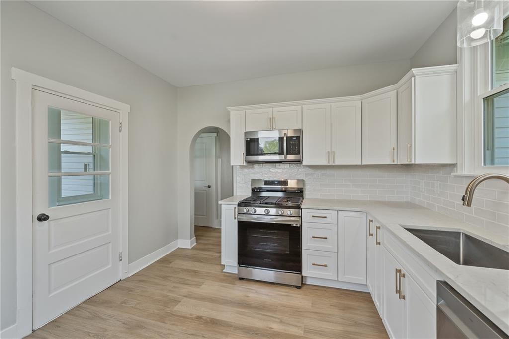 848 Ohio Avenue Monaca, PA 15061 - Photo 4 of 24 a kitchen with white cabinets stainless steel appliances and sink