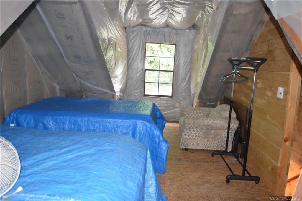 648 Sutton Road Waynesville, NC 28785 - Photo 14 of 24 a bedroom with a bed and a window