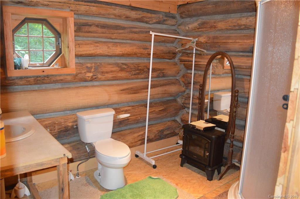 648 Sutton Road Waynesville, NC 28785 - Photo 9 of 24 a bathroom with a toilet sink and mirror